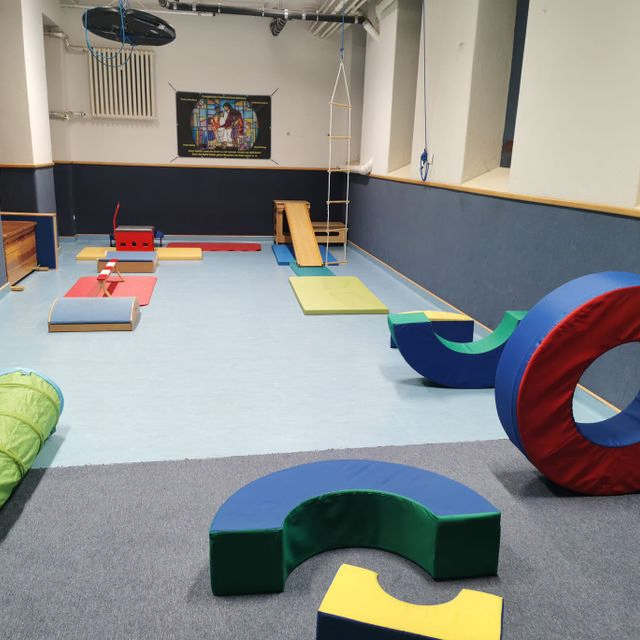 Indoor-Turnhalle für Kinder mit bunten Weichbausteinen und einem Tunnel.